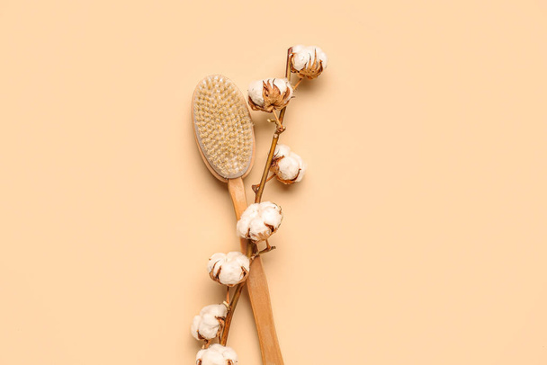 Massage brush and cotton branch on color background - Photo, Image