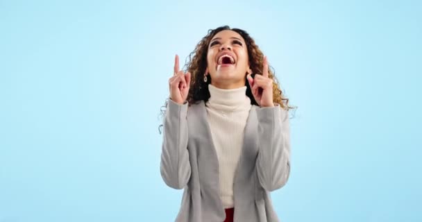Pointing up, excited and business woman in studio with yes, happy and announcement. Professional, mockup and portrait of person on blue background with hand gesture for news, promotion and emoji. - Footage, Video