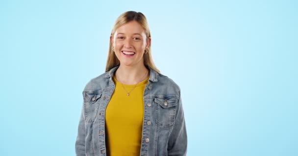 Young, woman and laugh with happiness in studio on blue background for mockup. Caucasian, model or person with confidence, smile or excitement for vacation, holiday or wellness in pose, stand or face. - Footage, Video