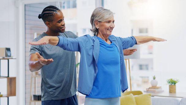 Rehabilitation, elderly woman and nurse for stretching exercise in a nursing home. Happy senior patient with a therapist man for healing, health and physiotherapy for arms, strong muscle and body. - Photo, Image