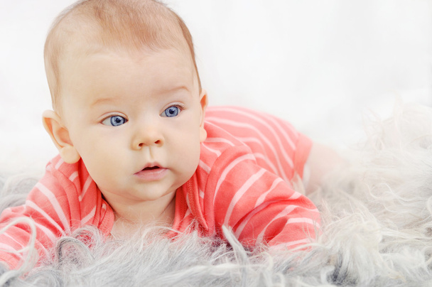 adorable cute little girl with big blue eyes on the sofa - Photo, Image