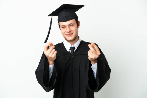 Mladá univerzita rusky absolvent izolované na bílém pozadí dělat peníze gesto - Fotografie, Obrázek