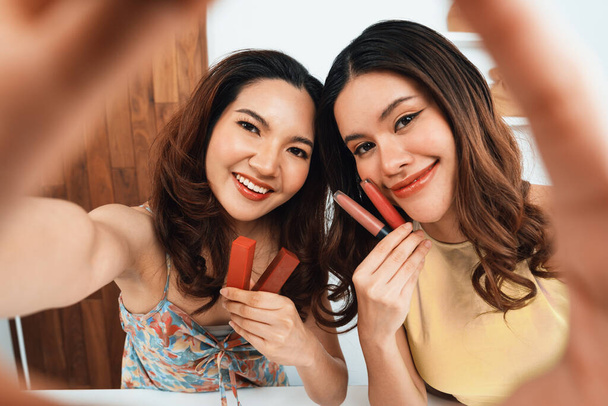 アジアの女性インフルエンサーは,ライブストリーミングビデオレビューメイクアップ最大のソーシャルメディアやブログを撮影します. オンラインでのマーケティングレコーディングセッション放送のための化粧品スタジオ照明を持つ幸せな若い少女 - 写真・画像