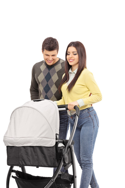 Young parents pushing baby stroller - Φωτογραφία, εικόνα