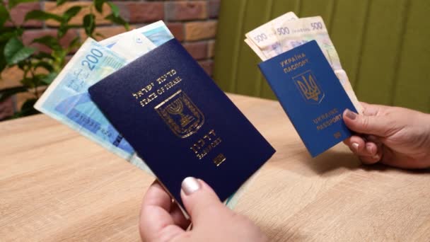 Passport of a citizen of Israel and passport of a citizen of Ukraine, repatriation, aliyah. Paper bills, new Israeli shekel and hryvnia. Absorption basket. Assistance under the Law of Return. - Footage, Video