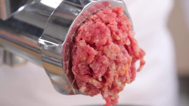 Putting minced meat through mincer - Footage, Video