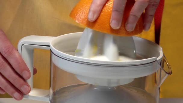 Squeezing orange with squeezer - Footage, Video