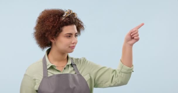 Waitress, pointing and face of woman in studio with list for options, decision and choice. Small business owner, cafe and person with hand gesture for promotion, deal and news on blue background. - Footage, Video