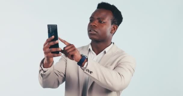 Phone, signal and black man in studio with no connection, network service and mobile problem. Business, professional and person on smartphone for message, email and communication on blue background. - Footage, Video