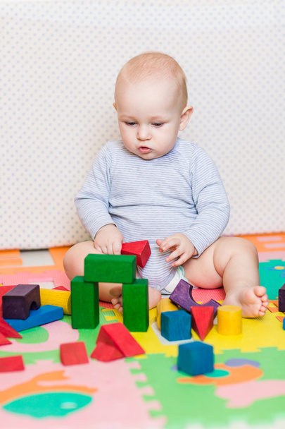 Cute little baby playing with colorful toys - Fotoğraf, Görsel