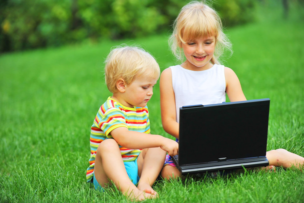 Girl and brother with laptop - Φωτογραφία, εικόνα