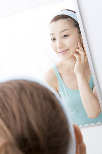 portrait of asian woman looking in the mirror - Fotó, kép