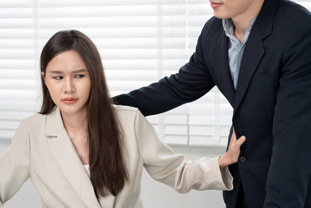 Manager or senior sexually harassed a female colleague by touch her shoulder. Sexual harassment in office. feel anxious and stressed from being harassed. molest, assault, inappropriate, discrimination - Photo, Image