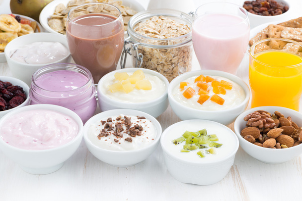 Assorted fruit yoghurts and breakfast ingredients - Fotó, kép