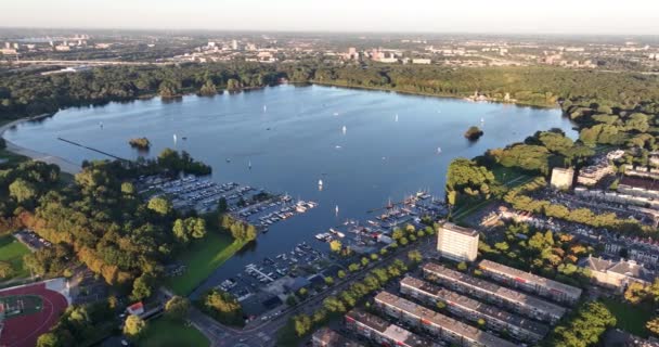 Veduta aerea drone della Kralingse Plas nella città di Rotterdam, Paesi Bassi. Lago ricreativo e Rotterdam punto di riferimento, natura, acqua, riva e attività ricreative all'aperto. - Filmati, video