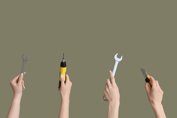 Electrician hands with tools on green background - Foto, Imagem