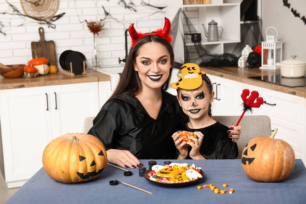 Bambina con sua madre e Halloween tratta in cucina - Foto, immagini