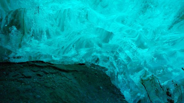 Beautiful ice in vatnajokull crevasse, massive blue blocks of ice structure melting because of climate change in iceland. Global warming affecting icelandic glacier and arctic scenery. Handheld shot. - Photo, Image