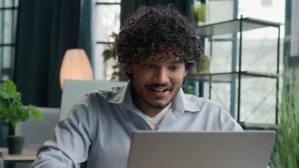 Excited shocked guy surprised Arabian Indian man office manager businessman looking at laptop computer screen shock wonder winning online bet victory business achievement success amazement goal reward - Footage, Video