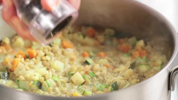 Seasoning lentil stew with pepper - Footage, Video