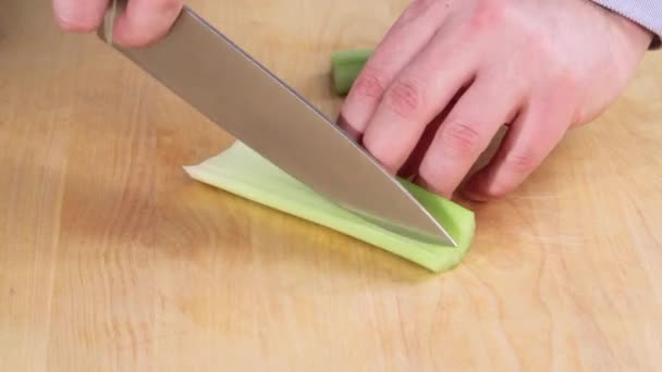 A peeled celery stick being diced - Footage, Video
