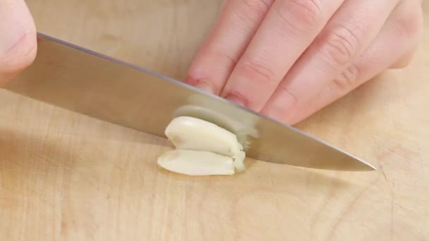 Garlic clove being chopped - Felvétel, videó