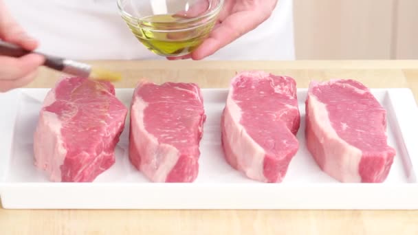 Steaks being brushed with oil - Footage, Video