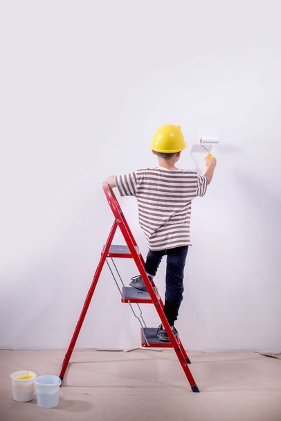 Boy painting wall during home renovation - Photo, Image