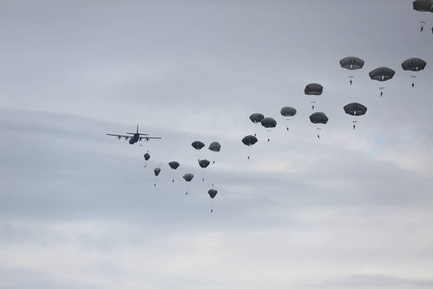 lots of parachutists in the cloudy sky  - Photo, Image