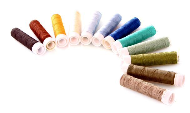 Semicircle of many-coloured bobbins of thread isolated on white - Фото, зображення