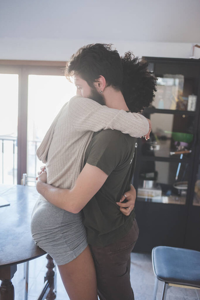 young multiethnic couple indoor hugging - Photo, Image