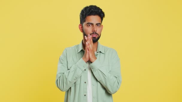 Stressed depressed Indian man terrified about danger problems, suffering phobia, anxiety disorder, expresses fear, waving no, insecure, stress, panic. Scared fearful guy on yellow studio background - Footage, Video