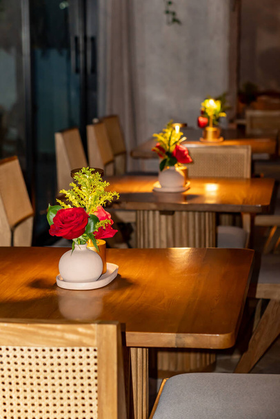 hermoso florero de lujo con flores en la mesa en la cafetería - Foto, imagen