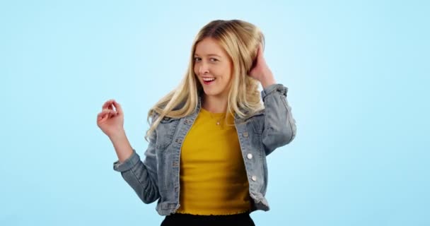 Woman, hair and face as studio mockup with confident funny carefree personality, beauty as portrait. Excited female model, happiness or smile on blue background, fashion or positive good mood or pose. - Footage, Video