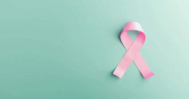 乳がん啓発キャンペーンコンセプト。 女性の医療。 ライトブルーの背景にあるピンクのリボンライティングのクローズアップ, トップビュー - 写真・画像