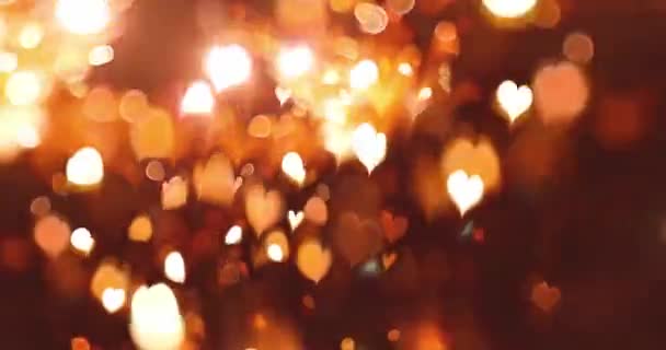 Cuore luminoso con effetto bokeh su sfondo nero. Sfondo romantico astratto movimento. San Valentino, Festa Evento, Matrimonio, Confetti, Natale, Diwali, Celebrazione, Capodanno. - Filmati, video