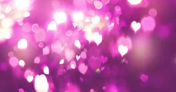 Pink color love heart glowing with bokeh effect on black background. Romantic Abstract Motion Background. Valentine's Day, Festival Event, Wedding, Confetti, Christmas, Diwali, Celebration, New Year. - Footage, Video