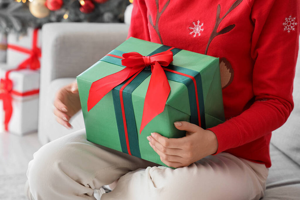 Жінка з подарунком вдома напередодні Різдва, крупним планом - Фото, зображення