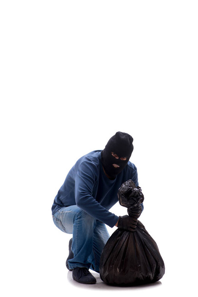 Nuori murtovaras varastaa rahaa eristyksissä valkoisella - Valokuva, kuva