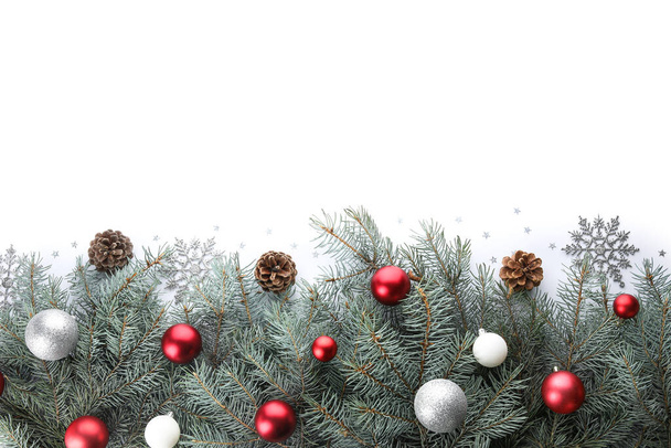 Vánoční strom větve s míčky, kornouty a sněhové vločky na bílém pozadí - Fotografie, Obrázek