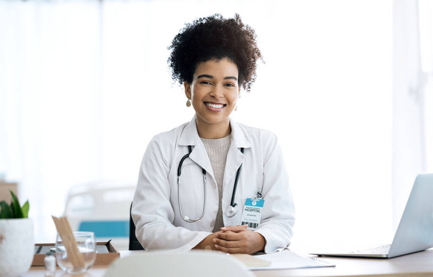 Professional, office and portrait of woman doctor at medical administration desk for medicine information and working. Confident, healthcare and happy worker with smile at surgeon table for insurance. - Photo, Image