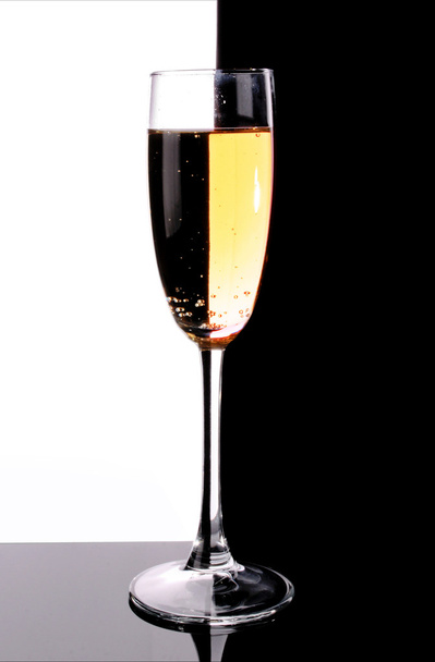 Glass with champagne on white and black background - Photo, image