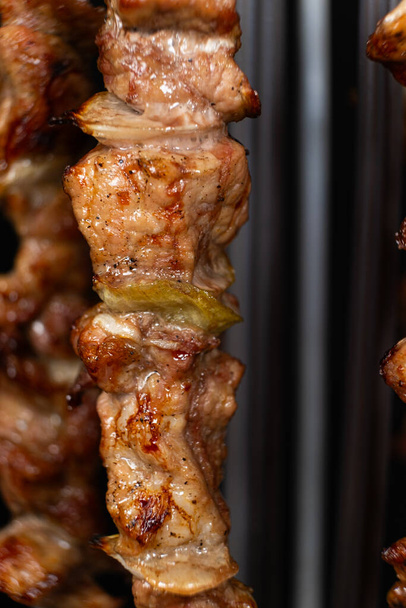 https://cdn.create.vista.com/api/media/small/678631870/stock-photo-cooking-pork-meat-electric-kebab-maker-vertical-skewers