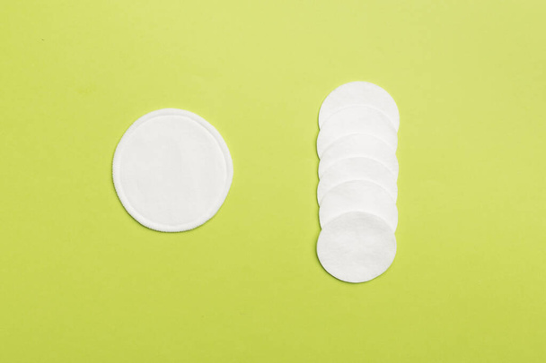 Reusable cotton pads with disposable ones on color background, top view - Fotó, kép