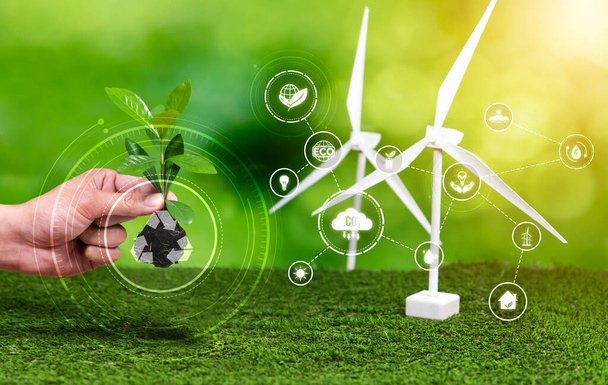 Sustainable energy technology with net zero emission and recycling waste management. Hand holding young plant with eco design icon symbolize ESG commitment for environmental protection. Reliance - Photo, Image