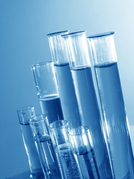 Test tubes on blue background - Foto, immagini