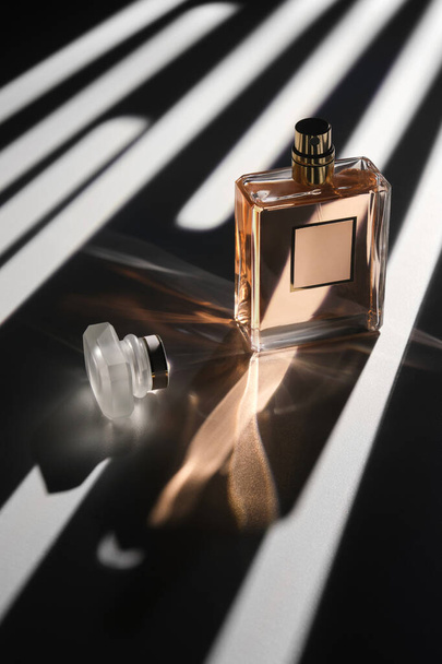 Glass perfume bottle. Stylish advertising composition of perfumes. Perfume advertising concept. - Photo, Image