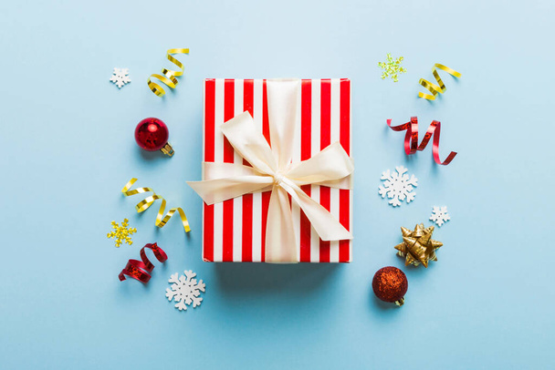 Top view Flat lay Christmas decorations and gift box on colored background with copy space. Christmas or Happy New Year composition. - 写真・画像