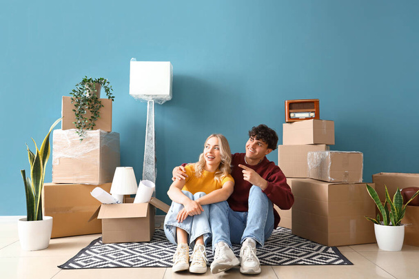 Happy young couple pointing at something in room on moving day - Photo, Image