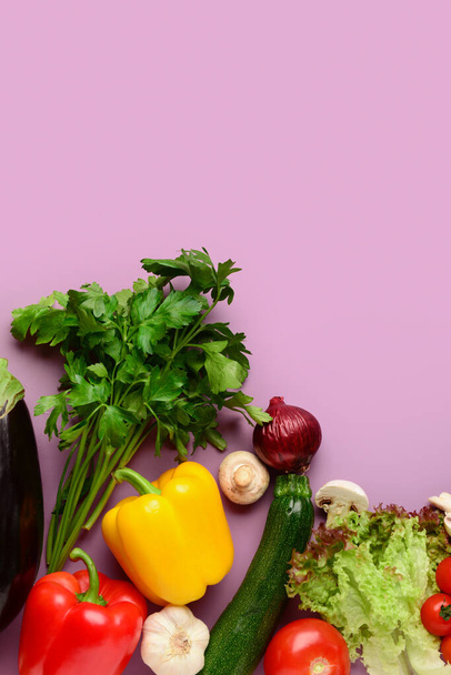 Different fresh vegetables on lilac background - Photo, Image